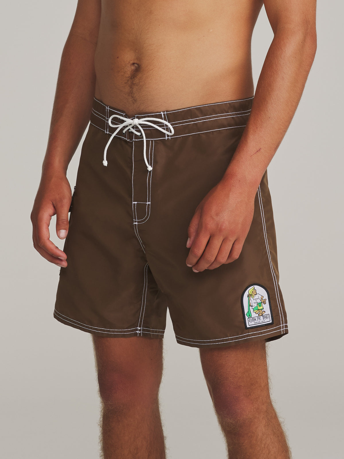 Katin Waterman Trunk in Cocoa, on model, side #color_cocoa