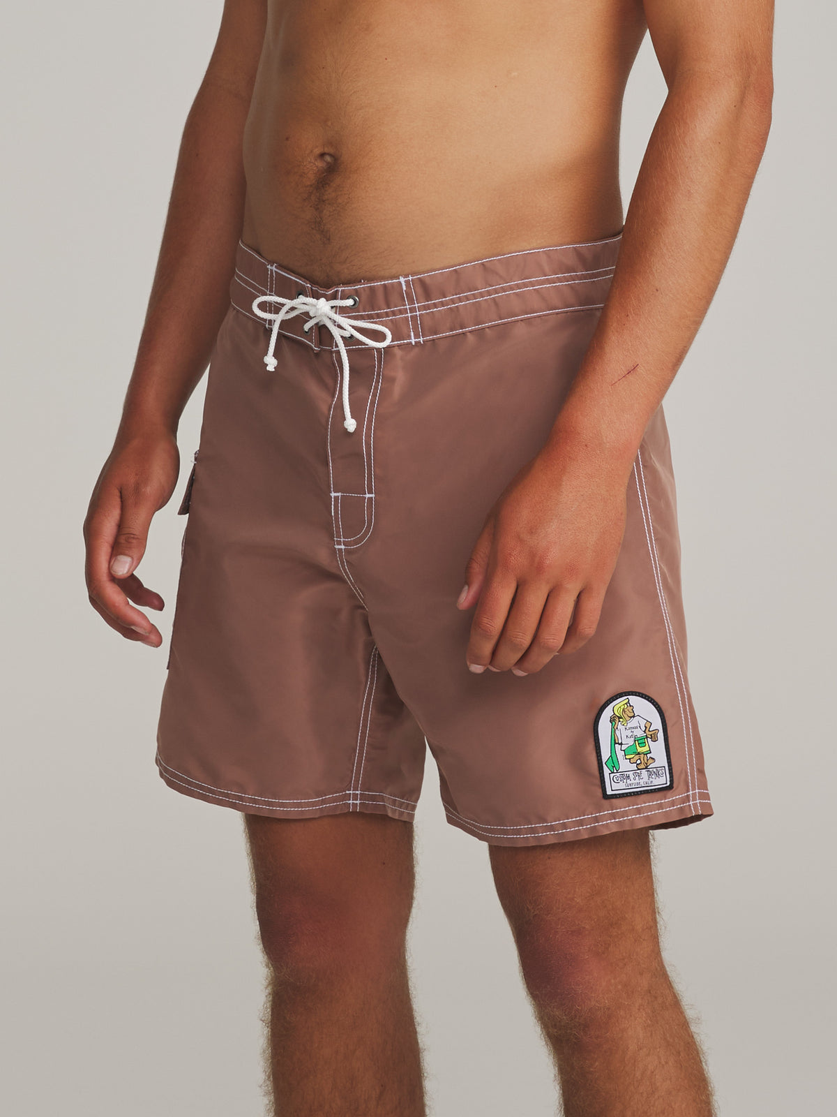 Katin Waterman Trunk in Dark Clay, on model, side #color_dark clay