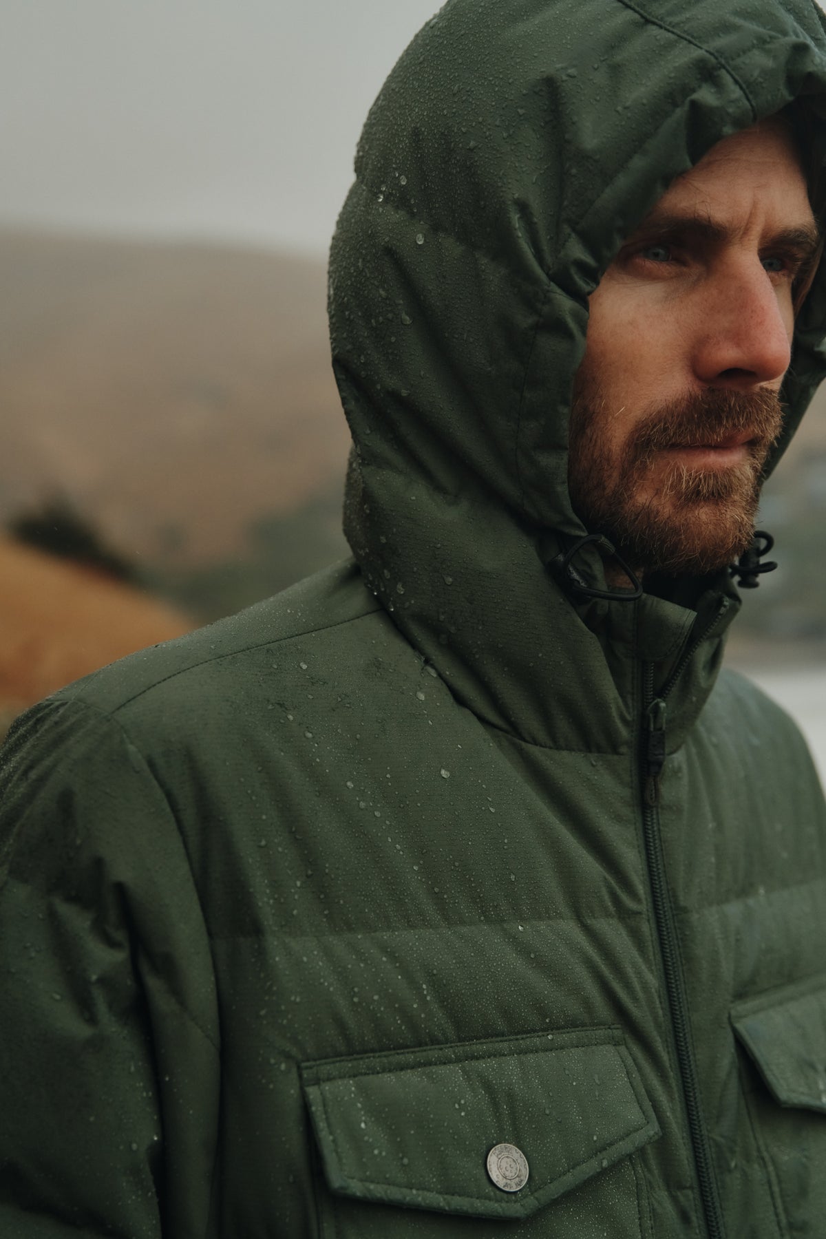 Katin OTG Summit Hooded Down Puffer in Thyme with a stacked fill pattern, on lifestyle, hood #color_thyme