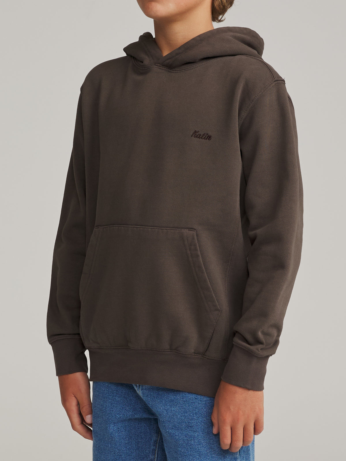 Katin Boys Embroidered Hoodie in Lead Vintage Wash heavyweight fleece with an embroidered Katin script logo, worn by a model, side view #color_lead vintage wash